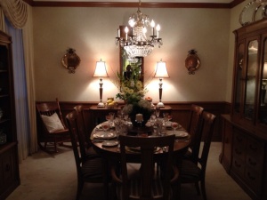 Dining Room - After The room has ambient lighting. Several layers of lighting is important. Overhead which must be dimmable and lighting at the eye level, such as lamps. The table cloth was removed and set with china a fresh flowers.