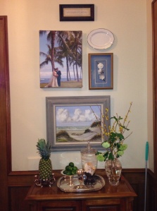 Patty and Blake love Hawaii. We gathered ocean, blue & white items to tell the story. The vignette showcases their wedding photos and  an antique seaside painting by a relative. 