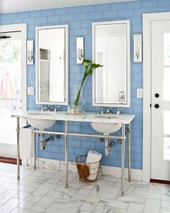 A fresh blue-and-white palette is carried throughout the house, even in the master bath, where Urban Archaeology tiles accent the walls. Maureen Footer designed the vanity, which was executed by Waterworks. 